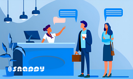 Visitors interacting with a receptionist at a modern front desk, highlighting the concept of digital visitor management and office check-in