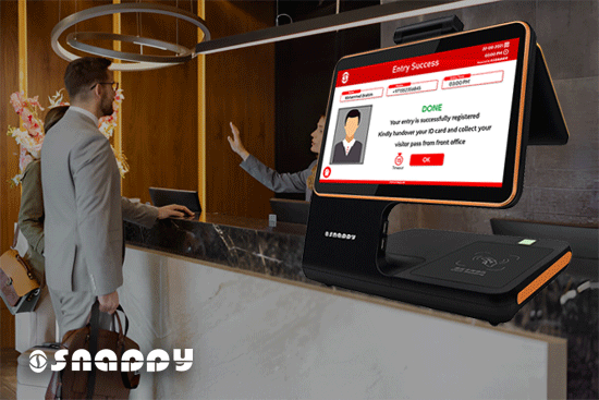 Snappy's smart visitor check-in device at a reception desk, with a digital screen showing successful entry registration