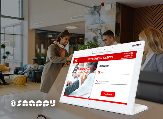 Visitors checking in at a modern office lobby using Snappy's visitor digital log book on a touchscreen kiosk, enhancing front desk efficiency and security